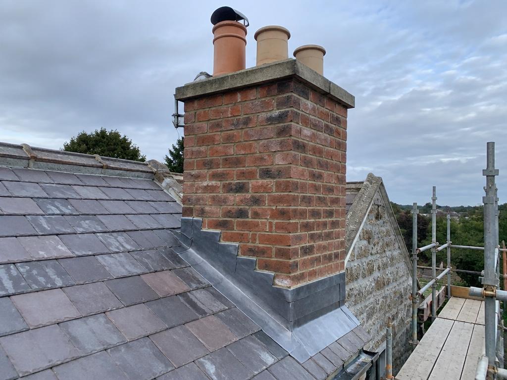 Repointed chimney stack with new lead flashing on a slate roof in Aberdeenshire